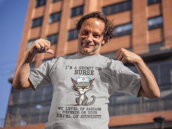 Man flexing arms and smiling while wearing the Funny Nurse T-Shirt featuring a grumpy cat with a sarcastic quote, premium heather grey cotton fabric