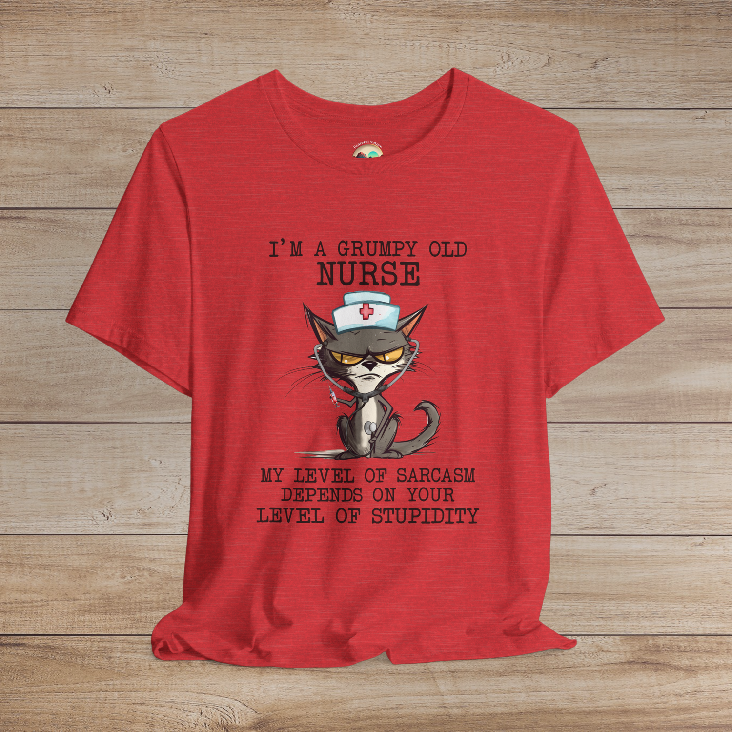 Funny Nurse T-Shirt featuring a grumpy cat in a nurse hat holding a syringe and stethoscope, with sarcastic quote, premium heather red fabric
