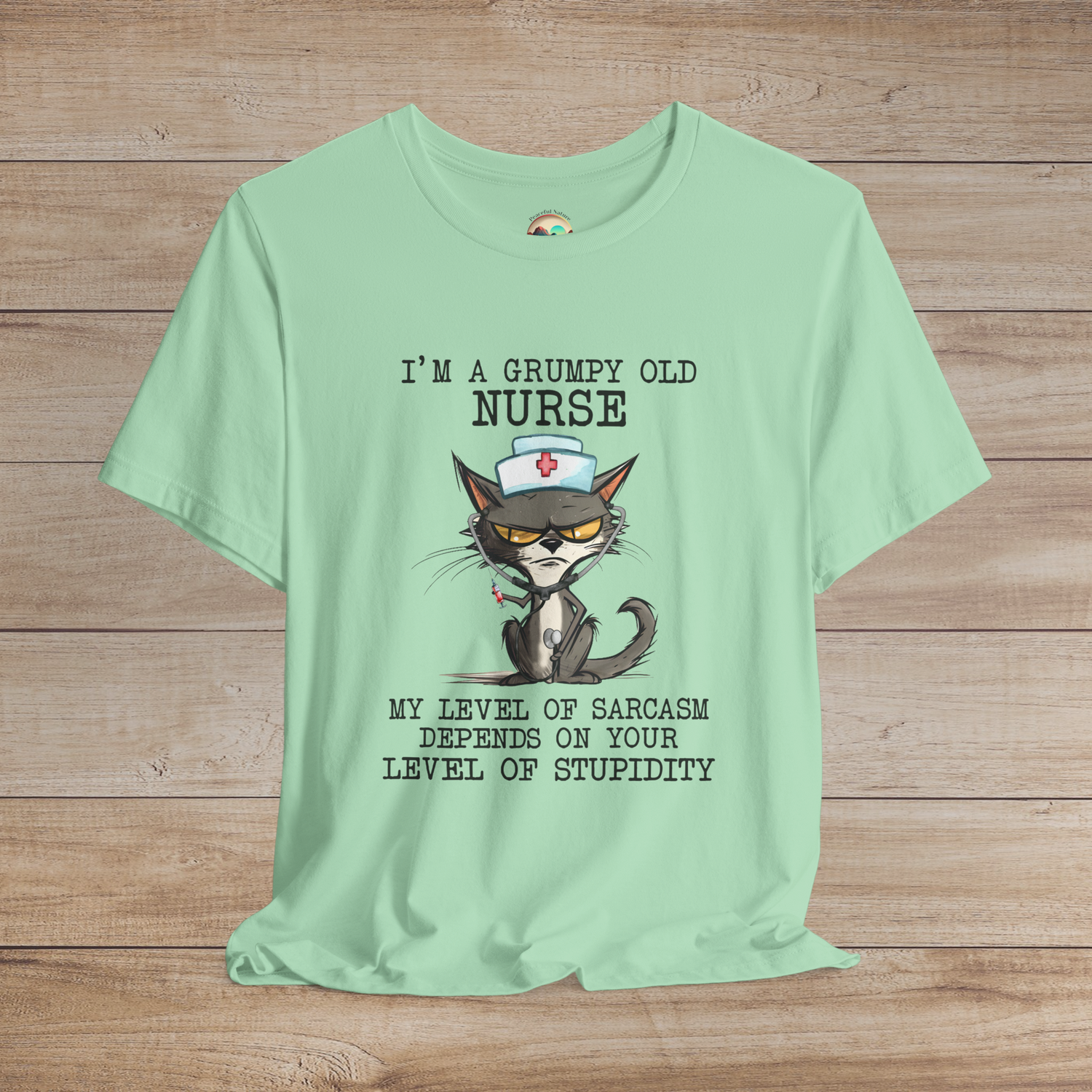 Humorous grumpy nurse cat t-shirt with syringe and stethoscope graphic, witty sarcasm quote, premium mint green fabric