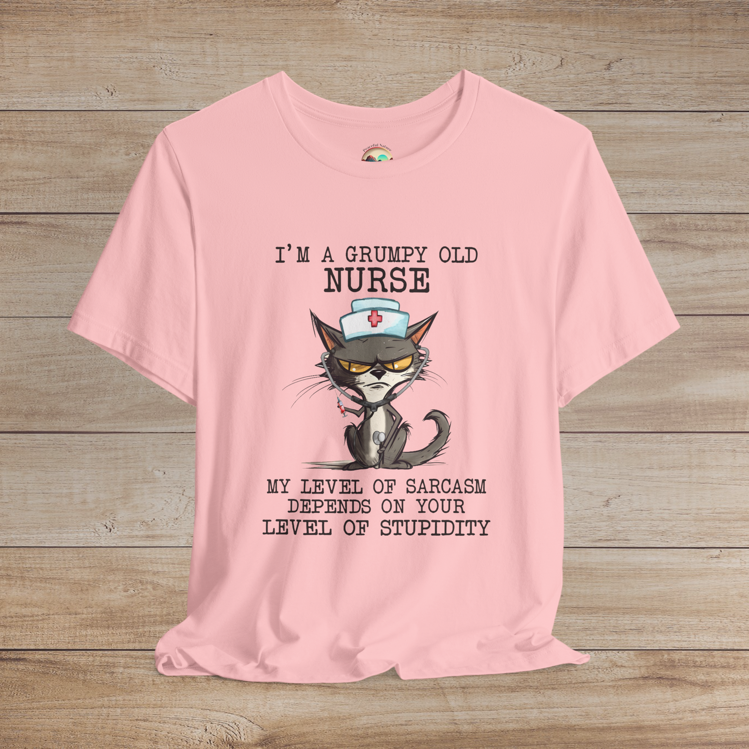 Cute but sarcastic nurse cat t-shirt, featuring a cranky cat in nurse hat and stethoscope, premium soft pink cotton fabric