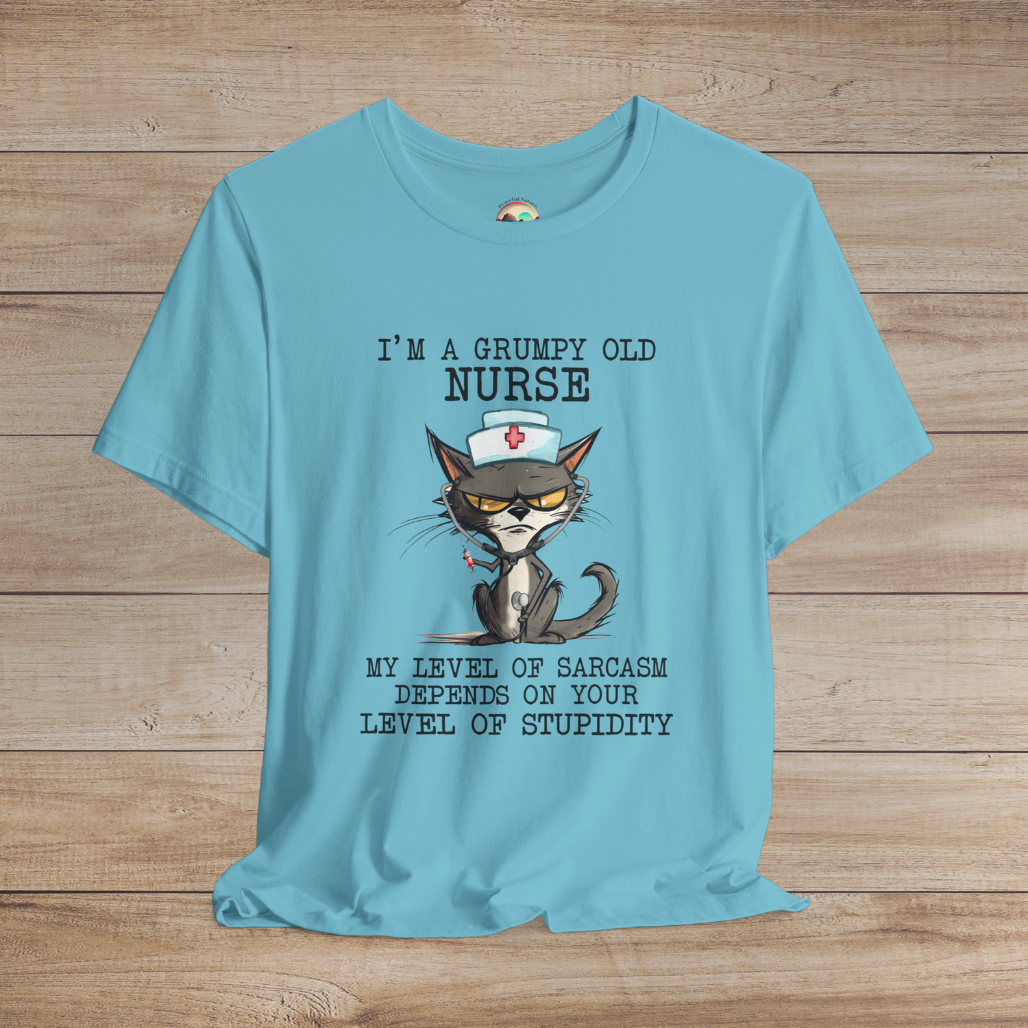 Sarcastic cat nurse t-shirt with funny quote, nurse hat, and syringe design, on vibrant turquoise premium tee