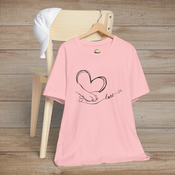 Pink t-shirt featuring clean black line art of a heart created by a human hand and a paw, connected by love script