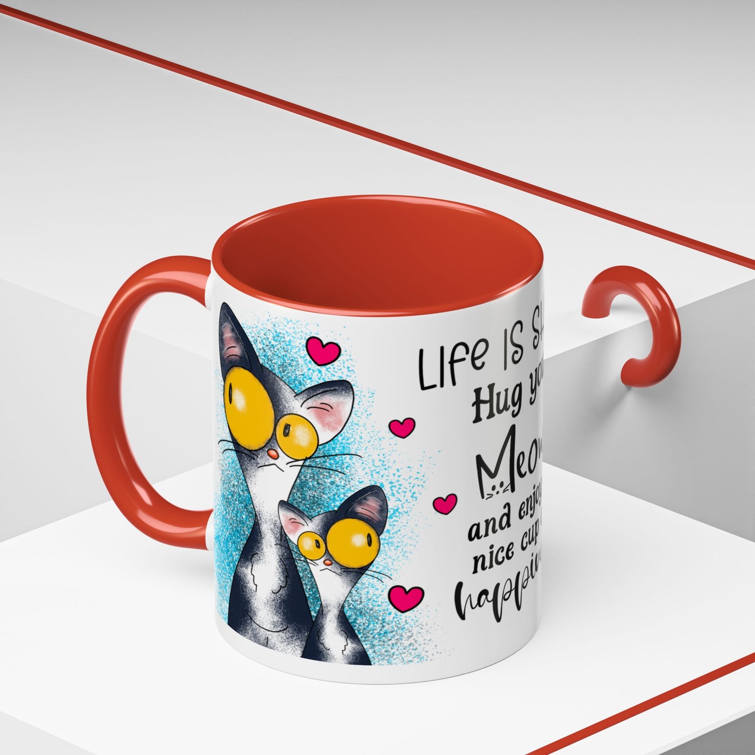 Left-side view of the 11 oz Hug Your Meow Mug with bright red trim and handle, showcasing two adorable cartoon cats with huge yellow eyes and whimsical hearts. A quirky and lovable mug for cat enthusiasts