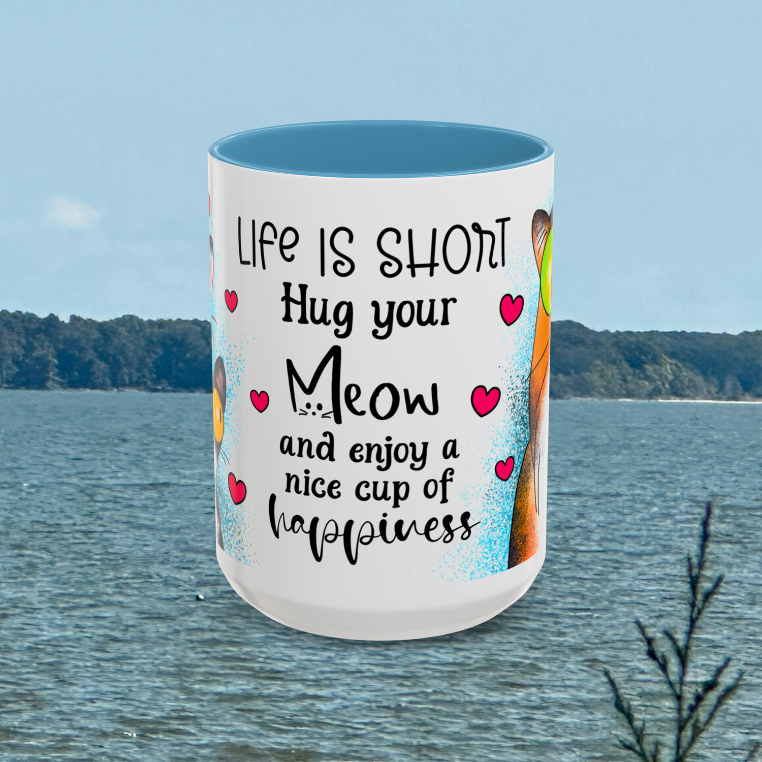 Front view of the 15 oz Hug Your Meow Mug featuring the phrase 'Life is short, Hug your Meow and enjoy a nice cup of happiness' in bold black font with pink hearts, accented with light blue trim. Ideal for cat moms and dads