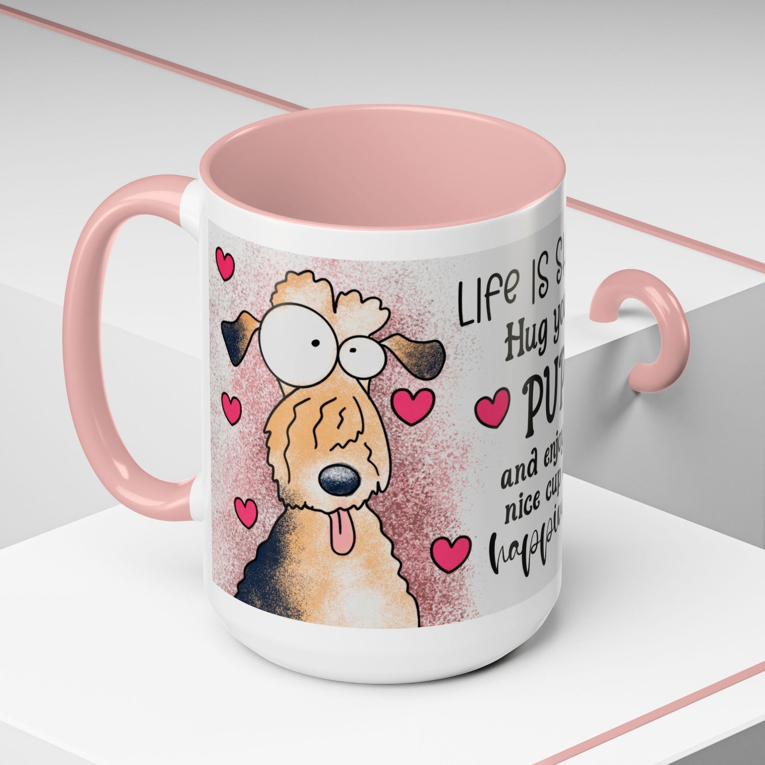 Left-side view of the 15 oz Hug Your Pup Mug, decorated with charming dog cartoon art, lovely pink interior, handle, and playful hearts. Includes the uplifting message 'Life is short, Hug your PUP and enjoy a nice cup of happiness.' Ideal for dog lovers