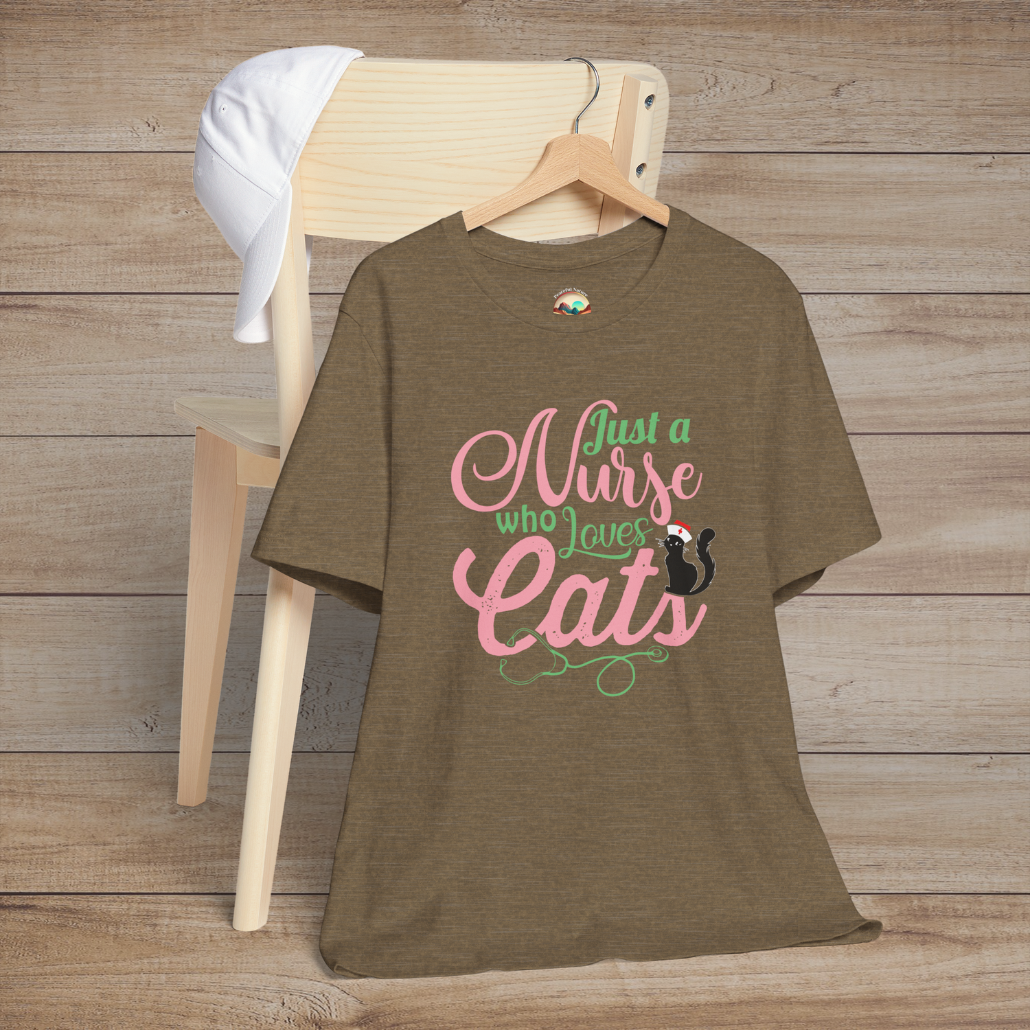 Heather olive t-shirt showing adorable black cat with nurse cap above pink and green script Just a Nurse Who Loves Cats