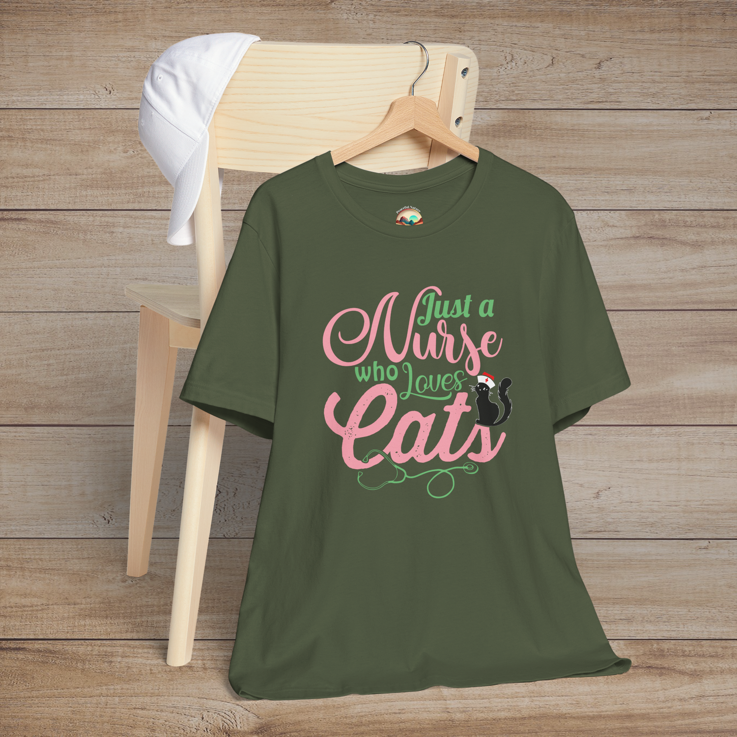 Military green t-shirt with fun design Just a Nurse Who Loves Cats in pink and green text featuring a sweet black cat nurse