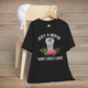 Black t-shirt featuring a white coffee cup illustration with pink roses and green leaves, captioned Just a Nurse Who Loves Coffee