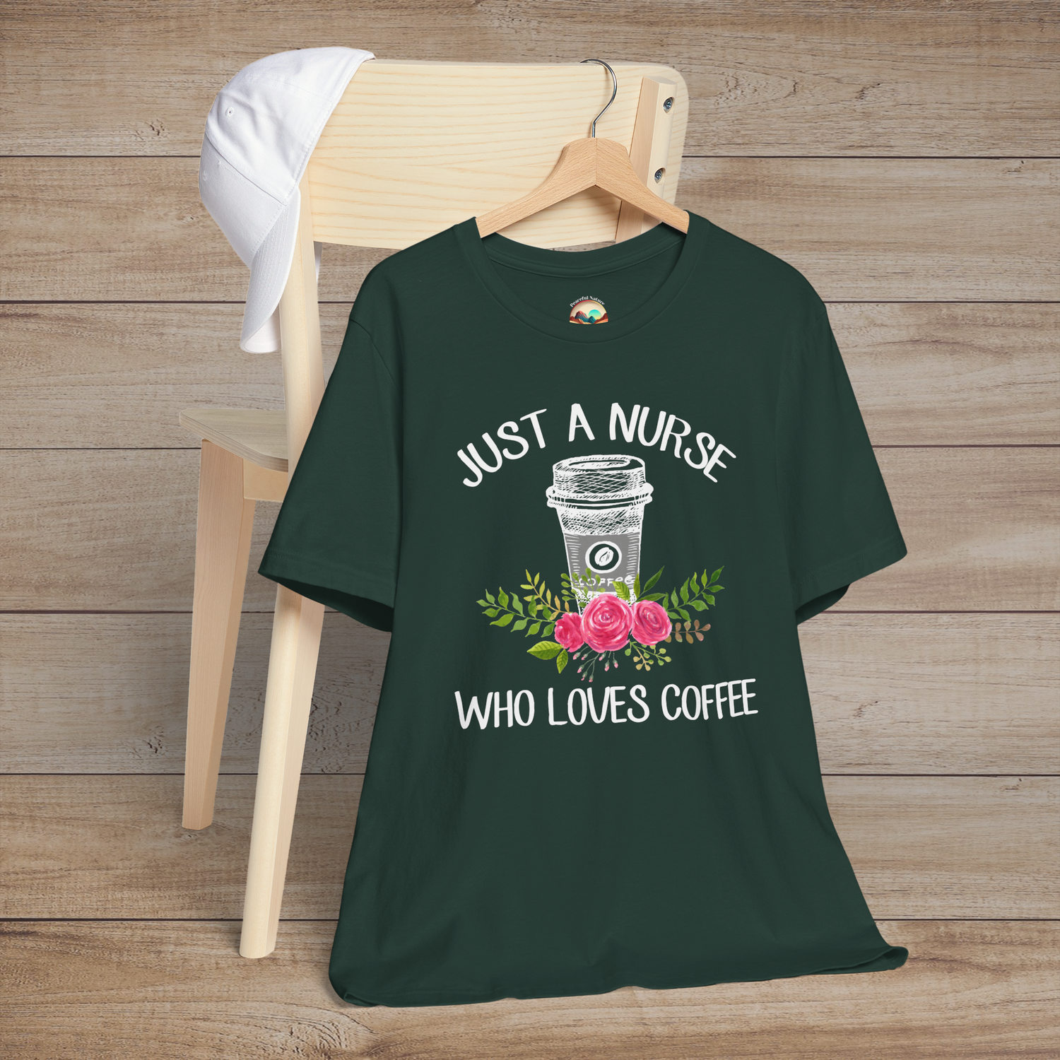 Forest green t-shirt featuring floral coffee-themed artwork with the phrase Just a Nurse Who Loves Coffee in playful white lettering