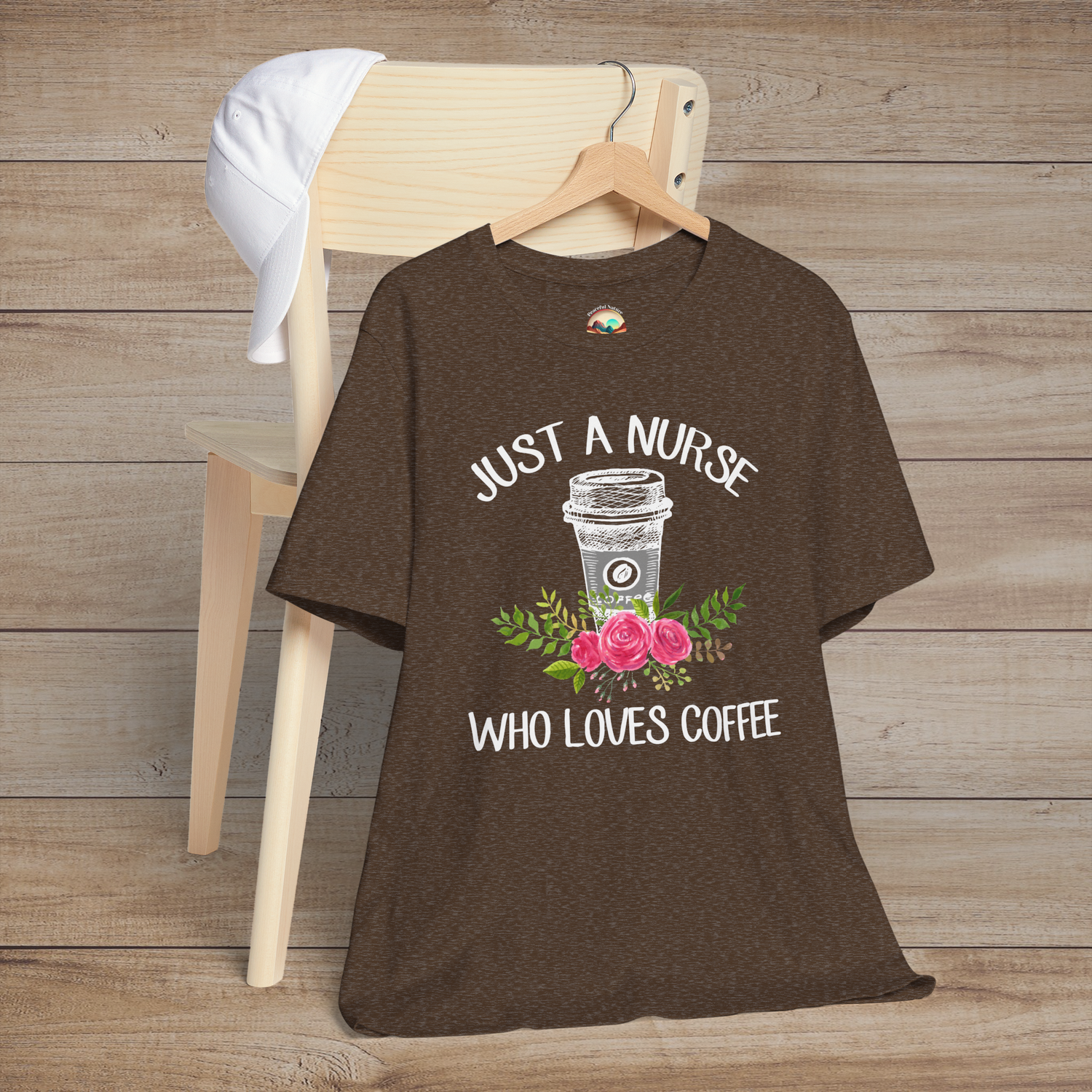 Heather brown t-shirt with sketch-style coffee cup surrounded by pink roses and green foliage, caption reads Just a Nurse Who Loves Coffee