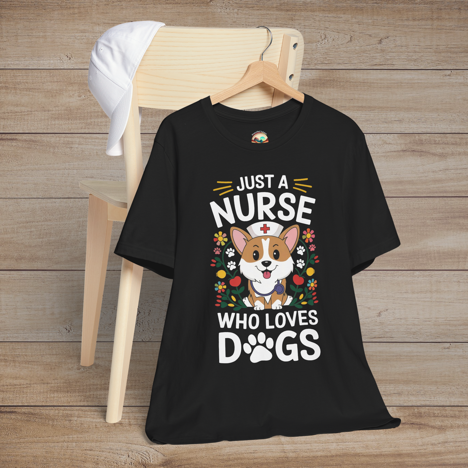 Black t-shirt featuring a cartoon dog wearing a nurse cap, surrounded by colorful flowers and paw prints, captioned Just a Nurse Who Loves Dogs