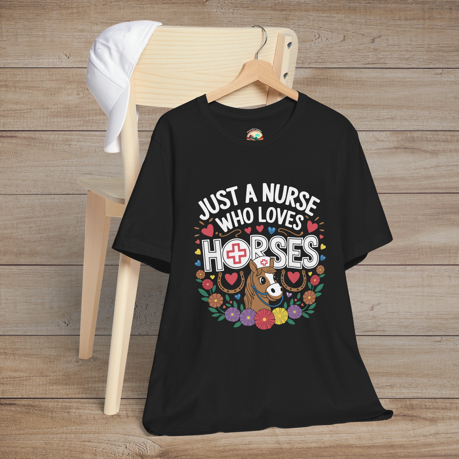 Just a Nurse Who Loves Horses T-Shirt in black, featuring a cute cartoon horse, flowers, hearts, and horseshoes – the perfect gift for horse-loving nurses