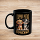 Black 11oz mug with Pixar-style puppies and “I Support Putting Animal Abusers to Sleep” slogan – left view