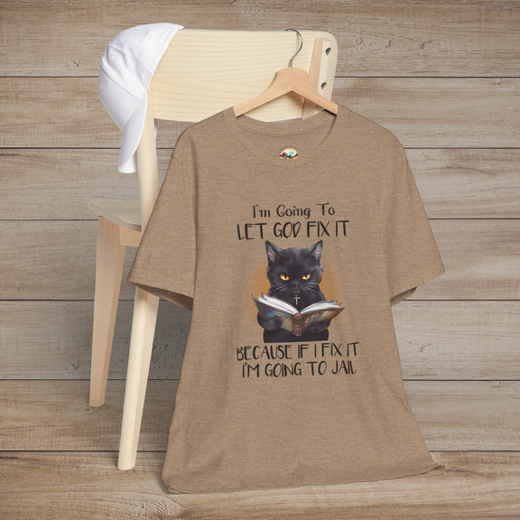 Heather tan Let God Fix It T-Shirt with a serious black cat holding a book and humorous faith-inspired message