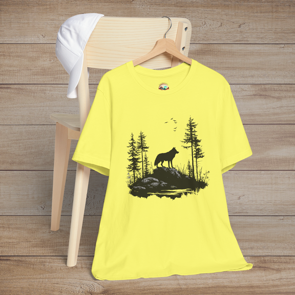 Bright yellow t-shirt with a black silhouette of a lone wolf standing on rocks amid a tranquil forest, birds flying overhead for a bold nature vibe