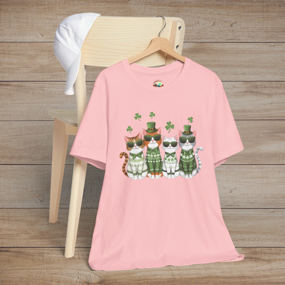 Pink t-shirt displaying festive St. Patrick’s Day cats wearing green outfits, sunglasses, and surrounded by shamrocks
