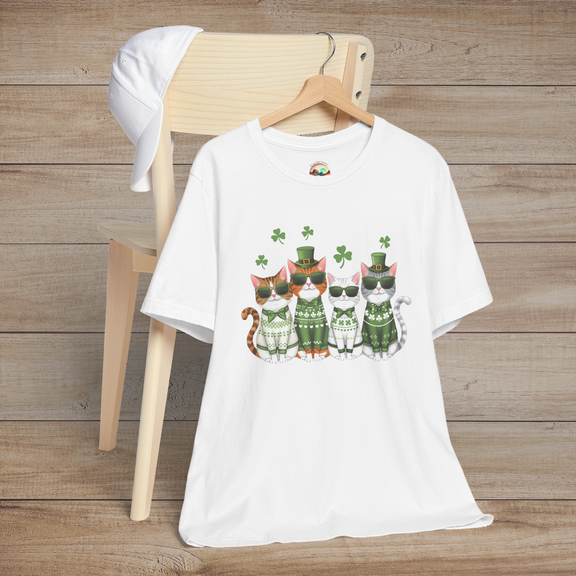 White t-shirt featuring adorable St. Patrick’s Day cats in festive green sweaters, glasses, and floating shamrocks