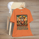 Burnt Orange Meowdy Partner Cowboy Cat Tee showcasing a humorous feline cowboy scene complete with hat, scarf, and desert cacti