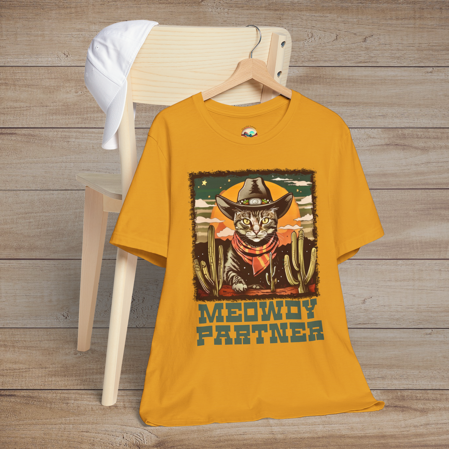 Mustard Yellow Meowdy Partner Funny Cowboy Cat T-Shirt featuring a cute feline cowboy wearing a hat and scarf amidst cacti in a vintage Western theme