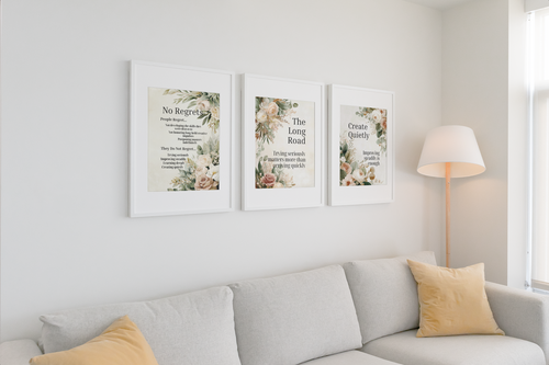 Framed botanical wall art prints with soft watercolor florals and reflective typography, displayed as a cohesive trio on a white wall