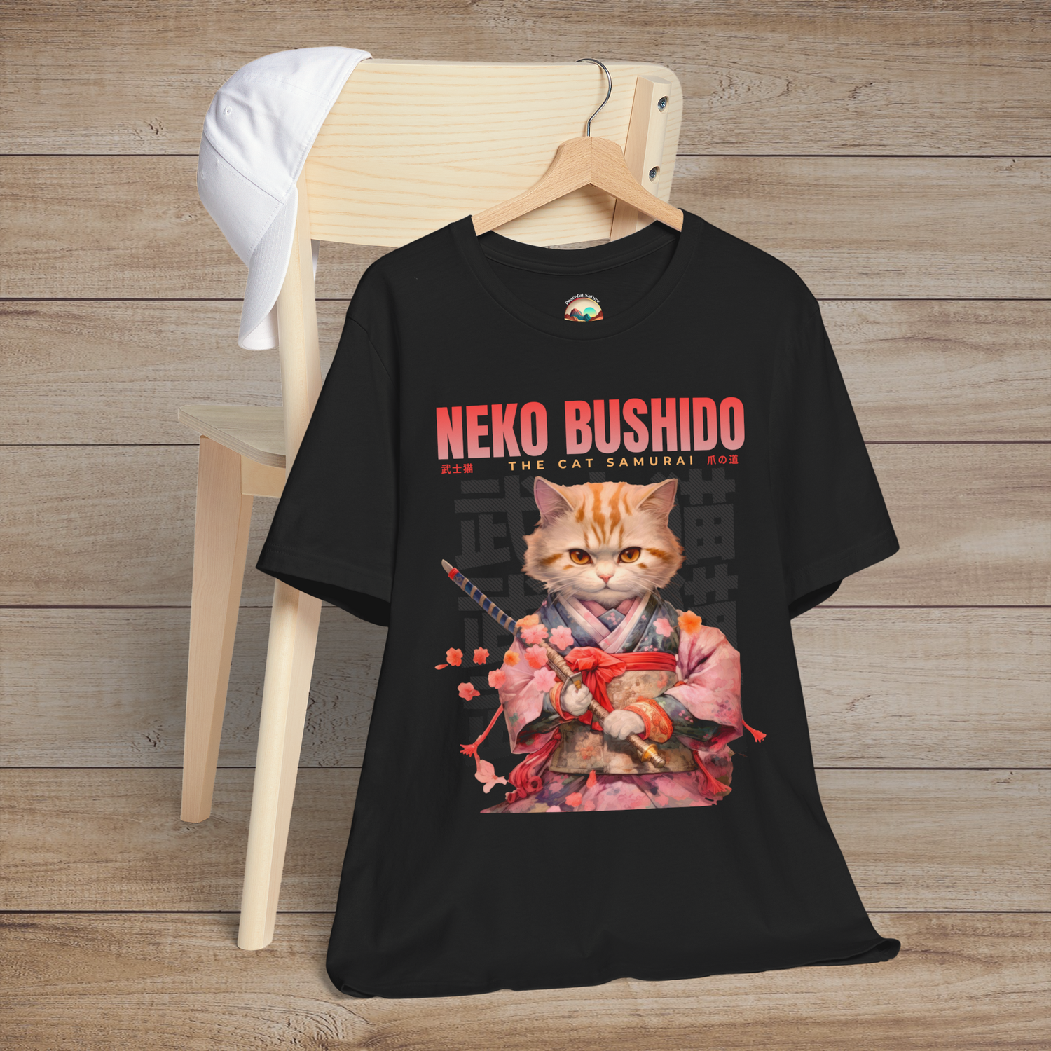 Black cat samurai t-shirt showing an orange cat in Japanese kimono, surrounded by cherry blossoms and bold text: 'Neko Bushido: The Cat Samurai'