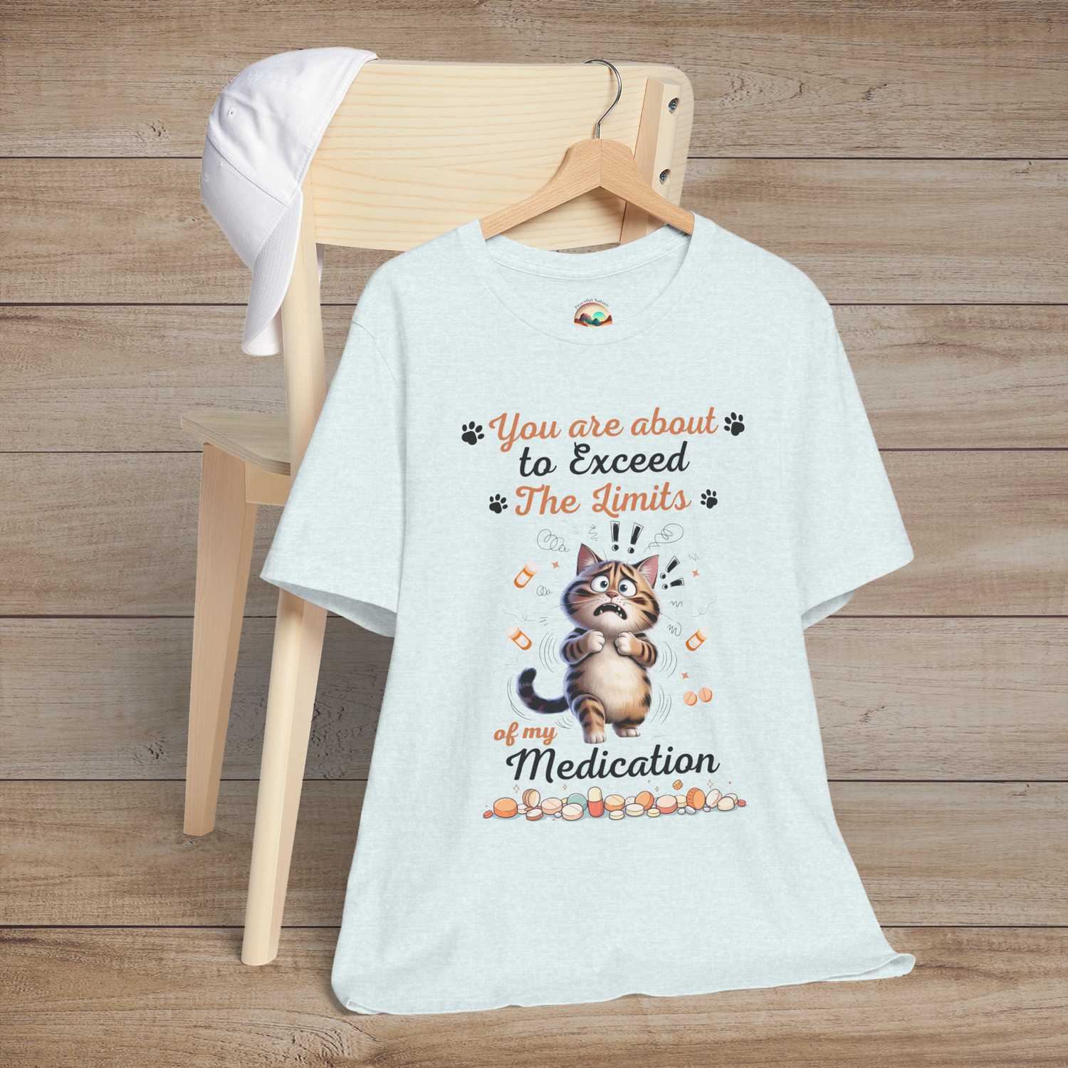 Funny heather ice blue t-shirt with a cat graphic and text on a wooden background