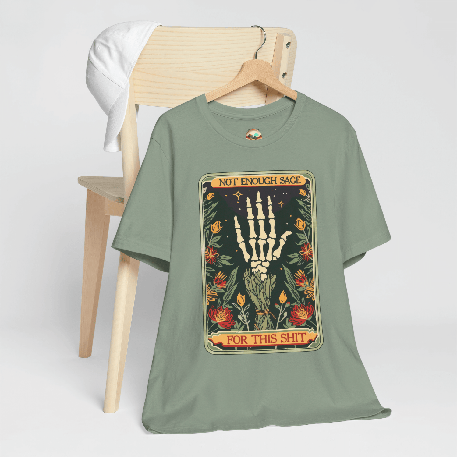 Sage Green Not Enough Sage for This Sh*t Graphic Tee, showcasing a humorous skeleton hand surrounded by sage plants, boho-goth style