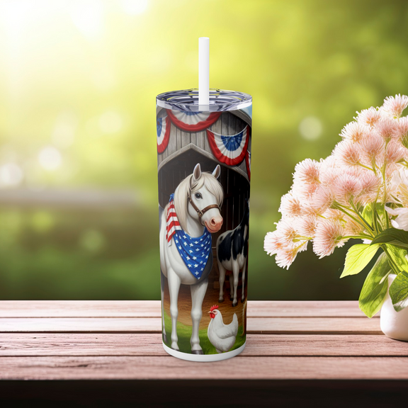Patriotic skinny tumbler with a white horse in stars-and-stripes bandana, barn backdrop with Fourth of July decorations