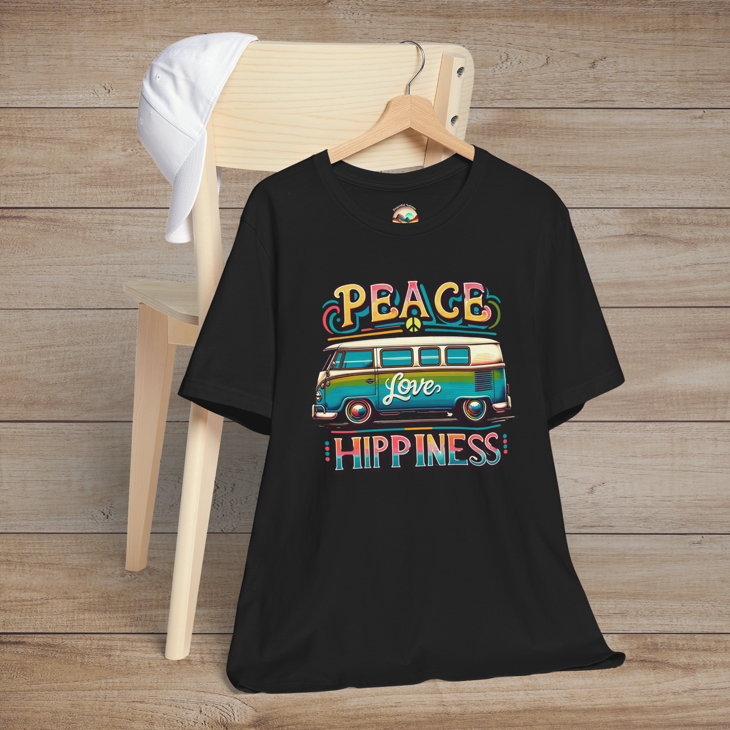 Black unisex t-shirt featuring a colorful retro van design with the words "Peace Love Hippiness"