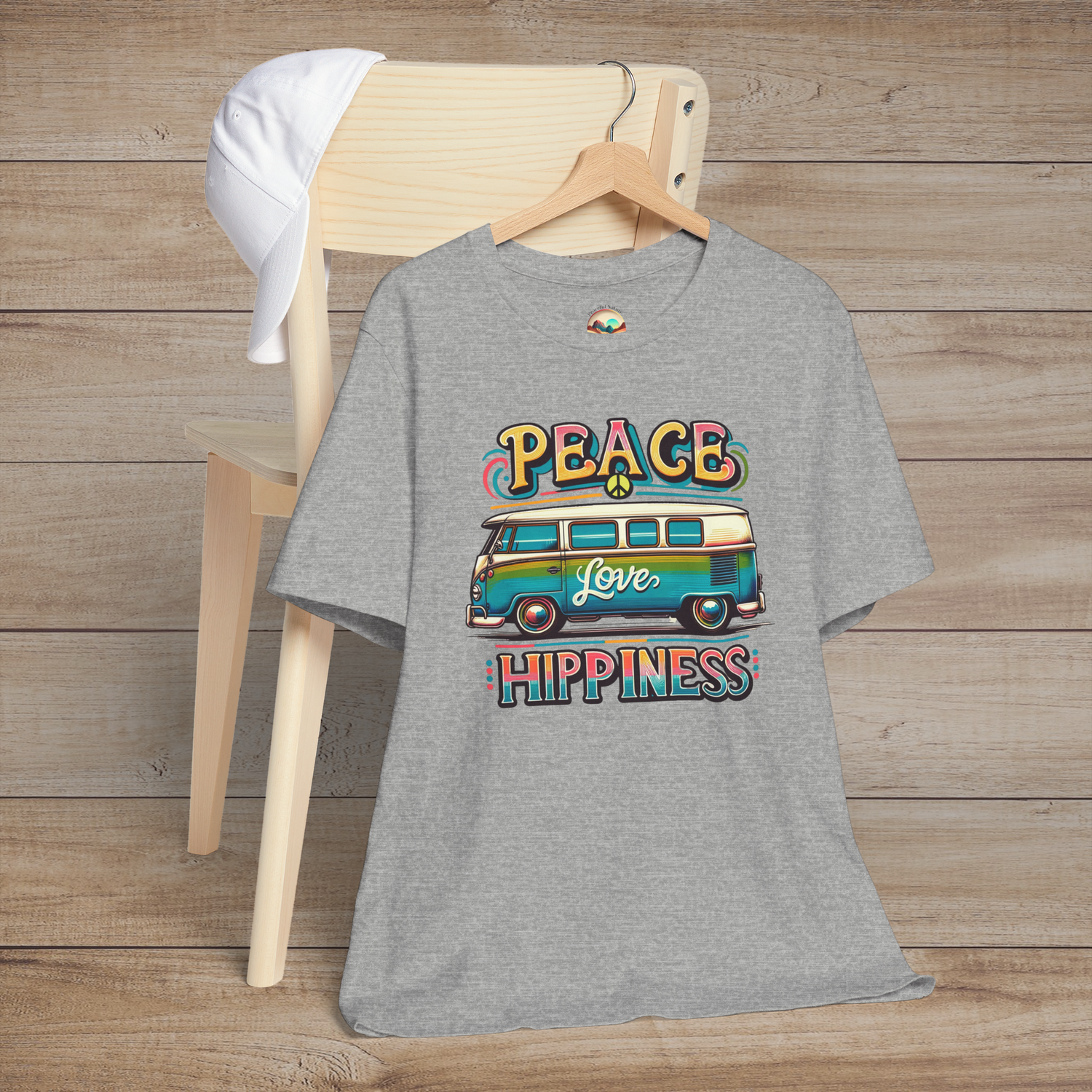 Heather grey unisex t-shirt featuring a colorful retro van design with the words "Peace Love Hippiness"