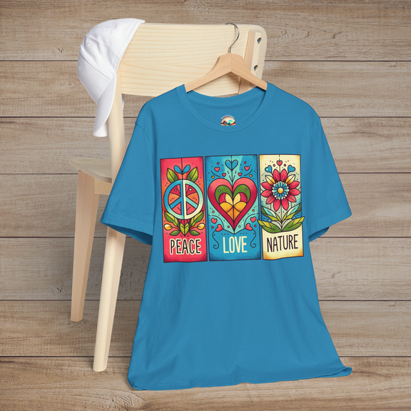 Aqua variant of the Peace Love and Nature T-Shirt displayed on a wooden chair, featuring a vibrant boho design with a peace sign, heart, and flower in bold retro colors. Perfect for free-spirited nature lovers