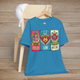 Aqua variant of the Peace Love and Nature T-Shirt displayed on a wooden chair, featuring a vibrant boho design with a peace sign, heart, and flower in bold retro colors. Perfect for free-spirited nature lovers