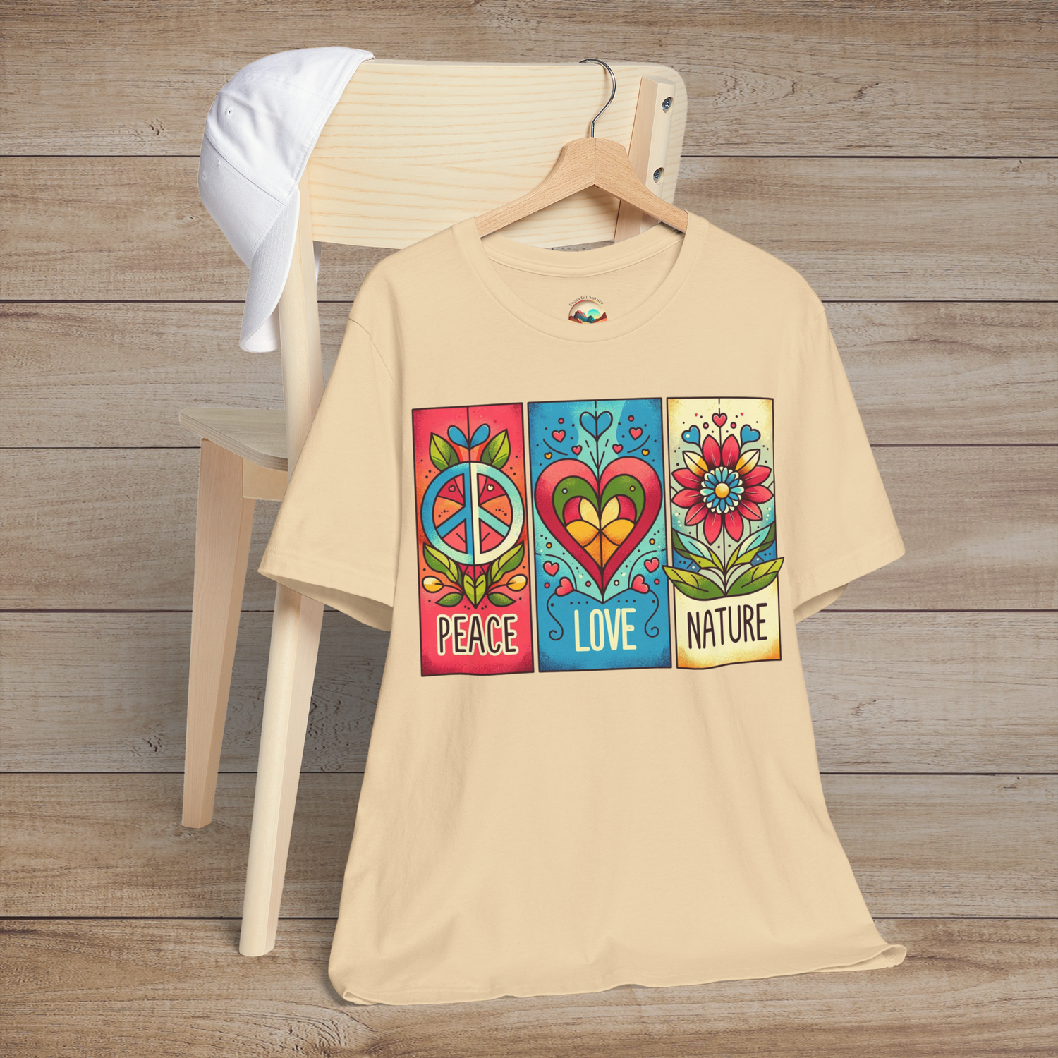 Soft cream Peace Love and Nature T-Shirt with a colorful boho print featuring a peace sign, heart, and daisy flower. A lightweight, premium tee for earthy, nature-loving minimalists