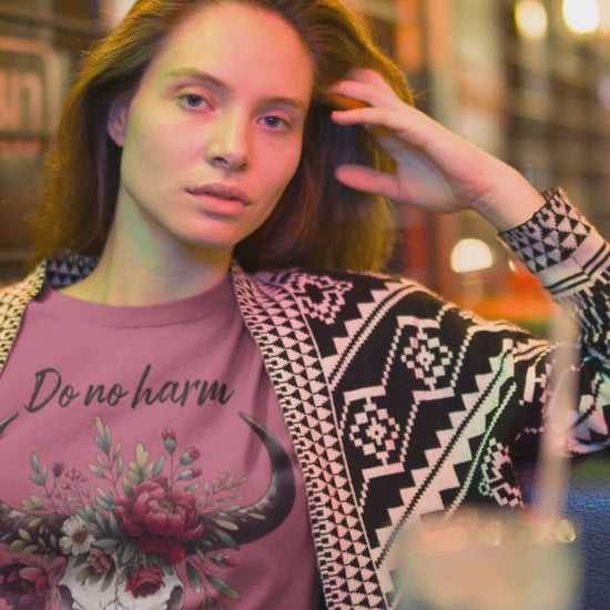 Woman modeling "Do No Harm But Take No Bull" t-shirt in heather raspberry with bull skull and floral crown