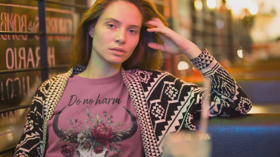 Woman modeling "Do No Harm But Take No Bull" t-shirt in heather raspberry with bull skull and floral crown