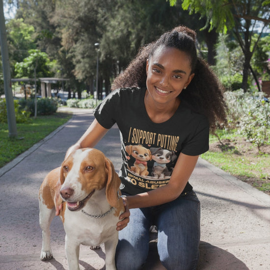 Video of moman kneeling on a path with a dog, wearing a t-shirt with a graphic design.