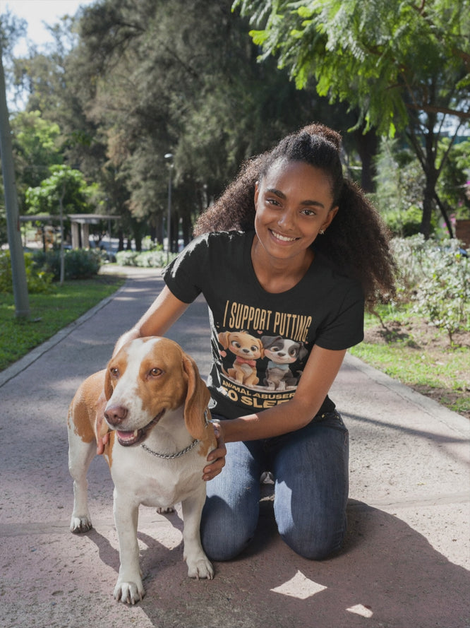 Video of moman kneeling on a path with a dog, wearing a t-shirt with a graphic design.