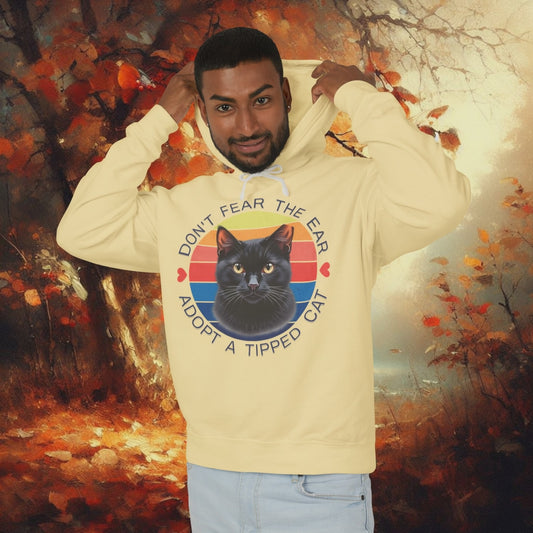 Video showcasing a butter-colored “Don’t Fear the Ear – Adopt a Tipped Cat” hoodie with a retro black cat design, promoting feral cat TNR awareness; rotating product view for cat lovers and rescue supporters.