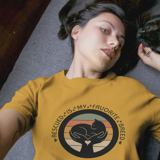 Video of woman with her cat. She is wearing the Rescued is my favorite breed tshirt.