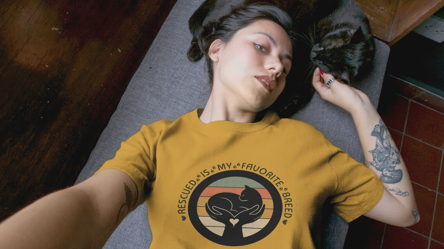 Video of woman with her cat. She is wearing the Rescued is my favorite breed tshirt.