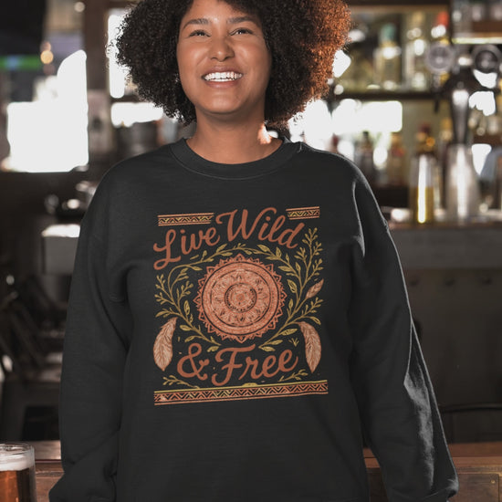 Video of a cheerful woman wearing the Live Wild & Free boho mandala sweatshirt in a sports bar-themed setting