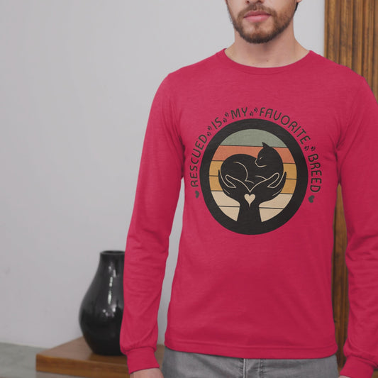 Video of man wearing True Red Sport-Tek long sleeve shirt with bright graphic and text saying "Rescued Is My Favorite Breed."