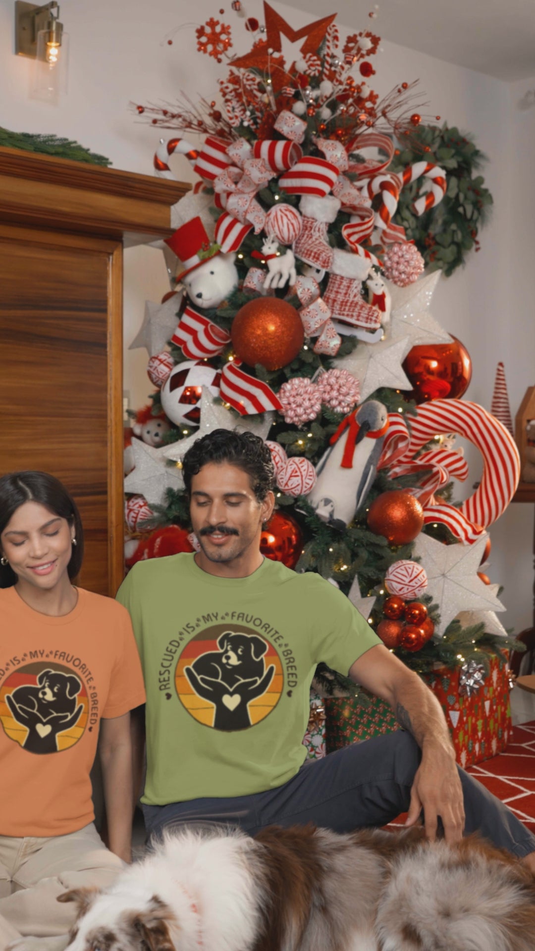 Video Rescued Is My Favorite Breed Puppy Tee worn by models in burnt orange and heather green at Christmas time.