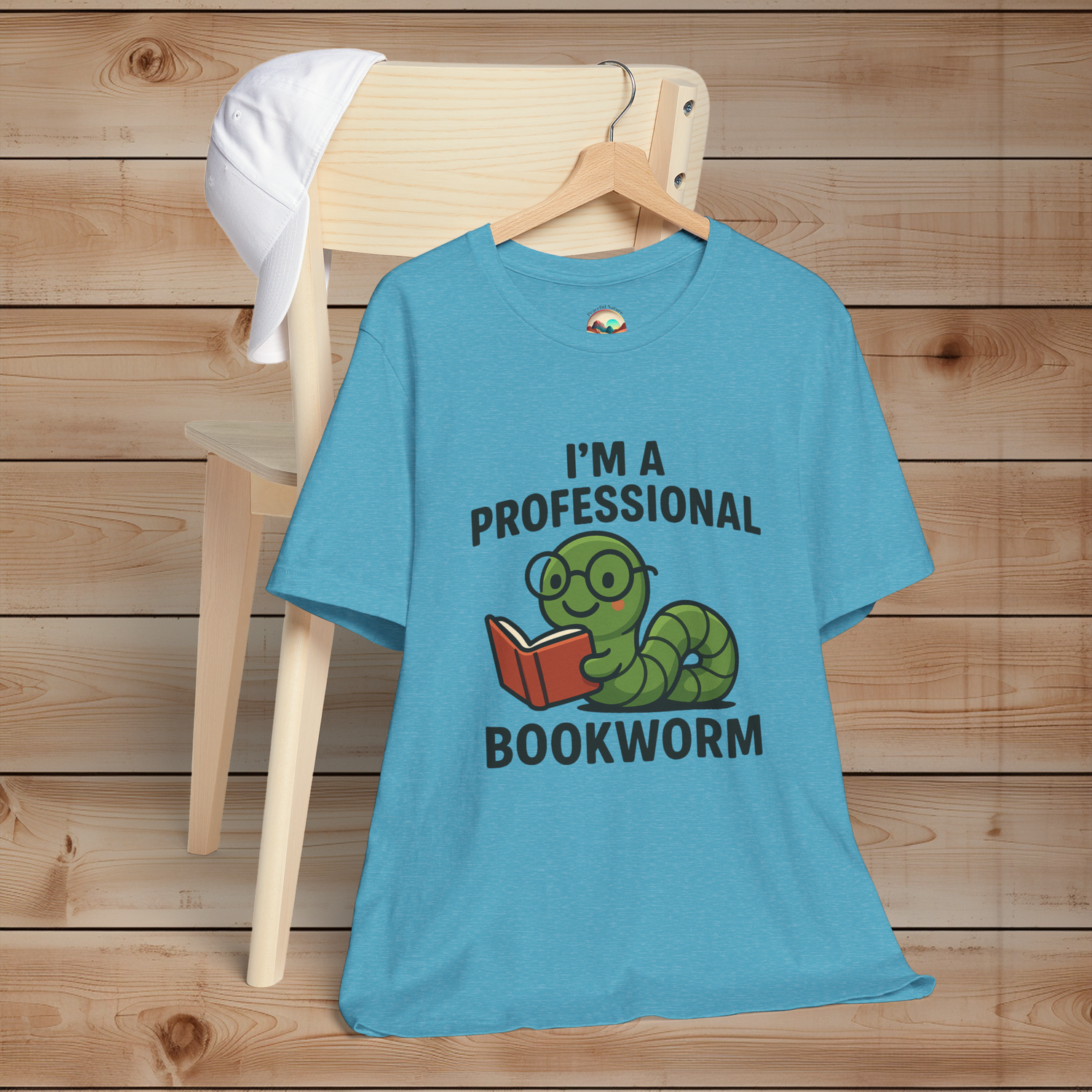 Heather aqua t-shirt with 'I'm a Professional Bookworm' graphic on a wooden chair.