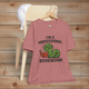 Heather mauve t-shirt with a graphic and text 'I'm a Professional Bookworm' on a wooden chair.