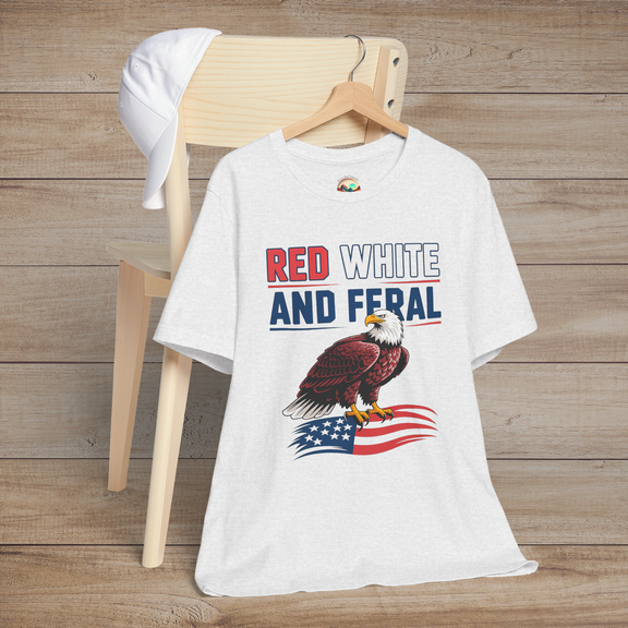 Patriotic eagle t-shirt in ash gray featuring the phrase "Red White and Feral" with a bold eagle perched on a waving American flag.