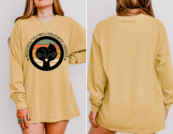 Mustard-colored long-sleeve Comfort Colors 6014 shirt, seen on model, with retro rescued cat design saying Rescued Is My Favorite Breed