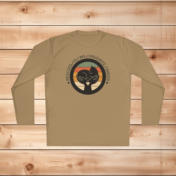 Coyote brown Sport-Tek long sleeve shirt with text saying "Rescued Is My Favorite Breed," with a black and white graphic on a wooden background
