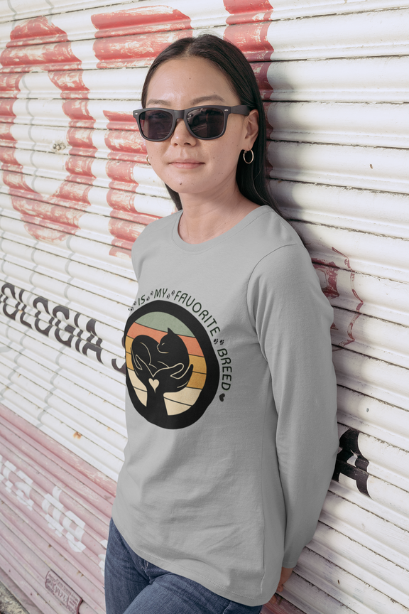 Woman wearing silver Sport-Tek long sleeve shirt with bright graphic and text saying "Rescued Is My Favorite Breed."