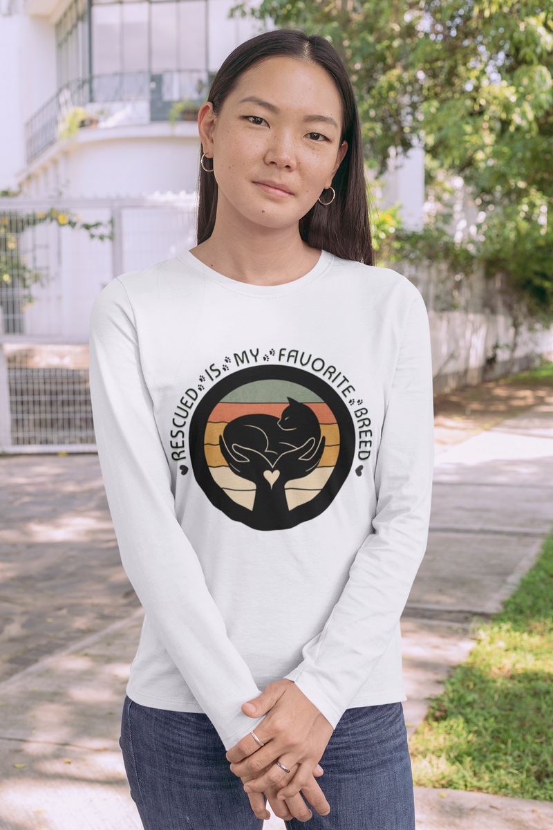 Woman wearing white Sport-Tek long sleeve shirt with bright graphic and text saying "Rescued Is My Favorite Breed."